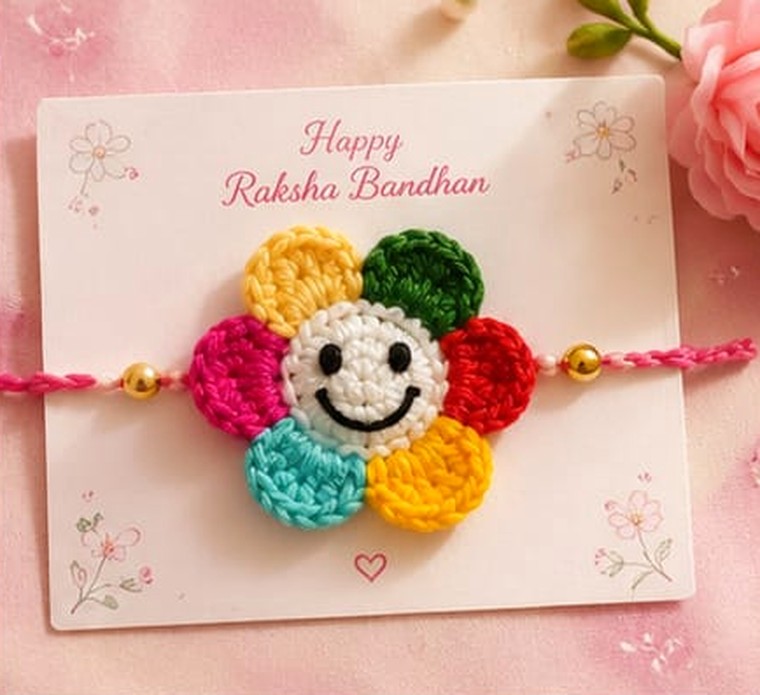 Handmade crochet rakhi with smiling face and rainbow petals